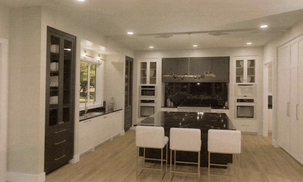 a view of a living room filled with furniture and a fireplace
